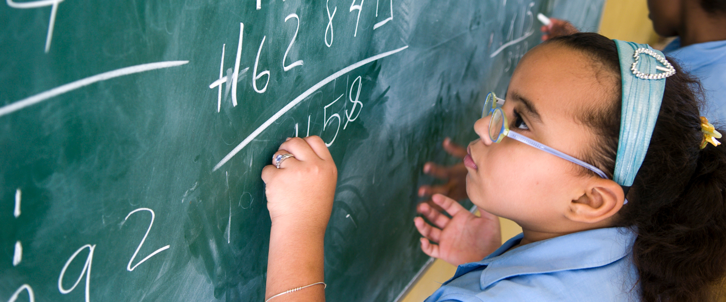 student at chalkboard